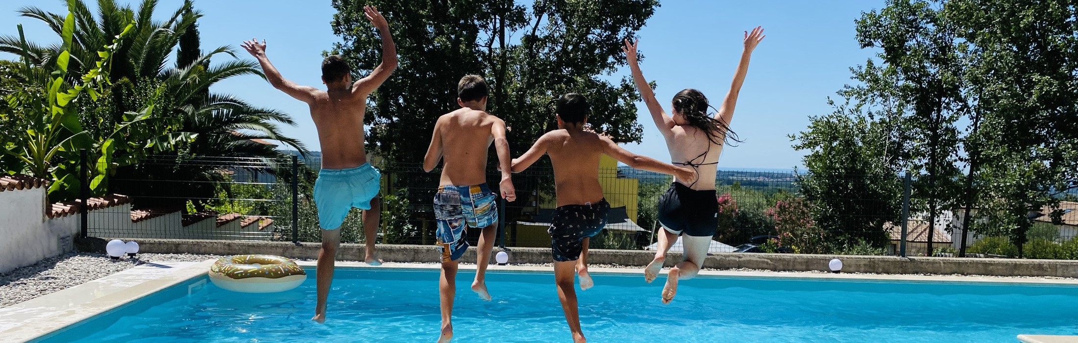 Kinder springen in den Pool